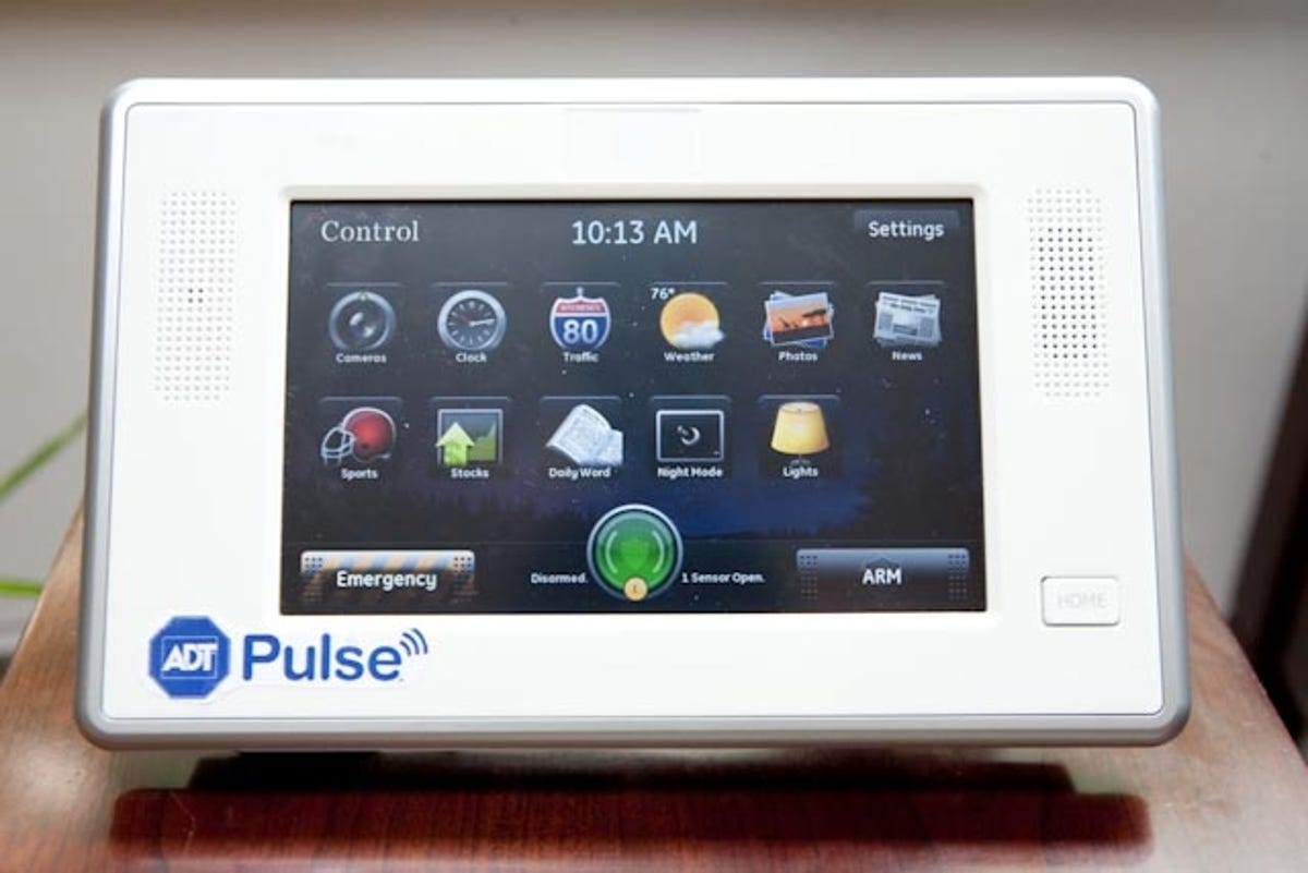 The ADT Pulse system can be accessed through a PC, smart-phone application, or dedicated device for controlling thermostat, lights, cameras, and home security settings.