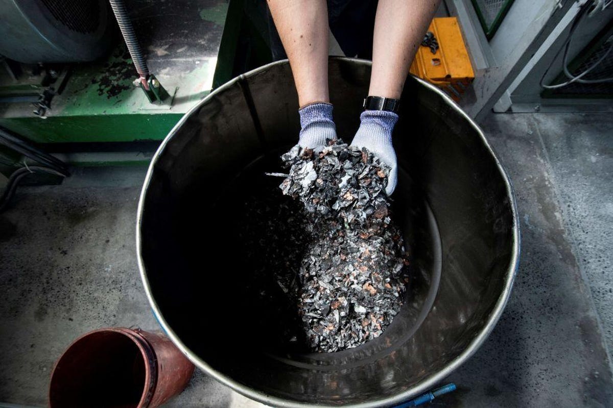 Person holding recycled metals from batteries