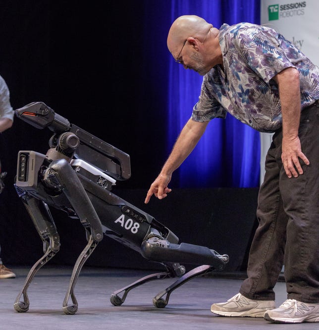 Boston Dynamics founder Marc Raibert shows where SpotMini "butt-cam" is located. The robot quadruped descends stairs rump-first.