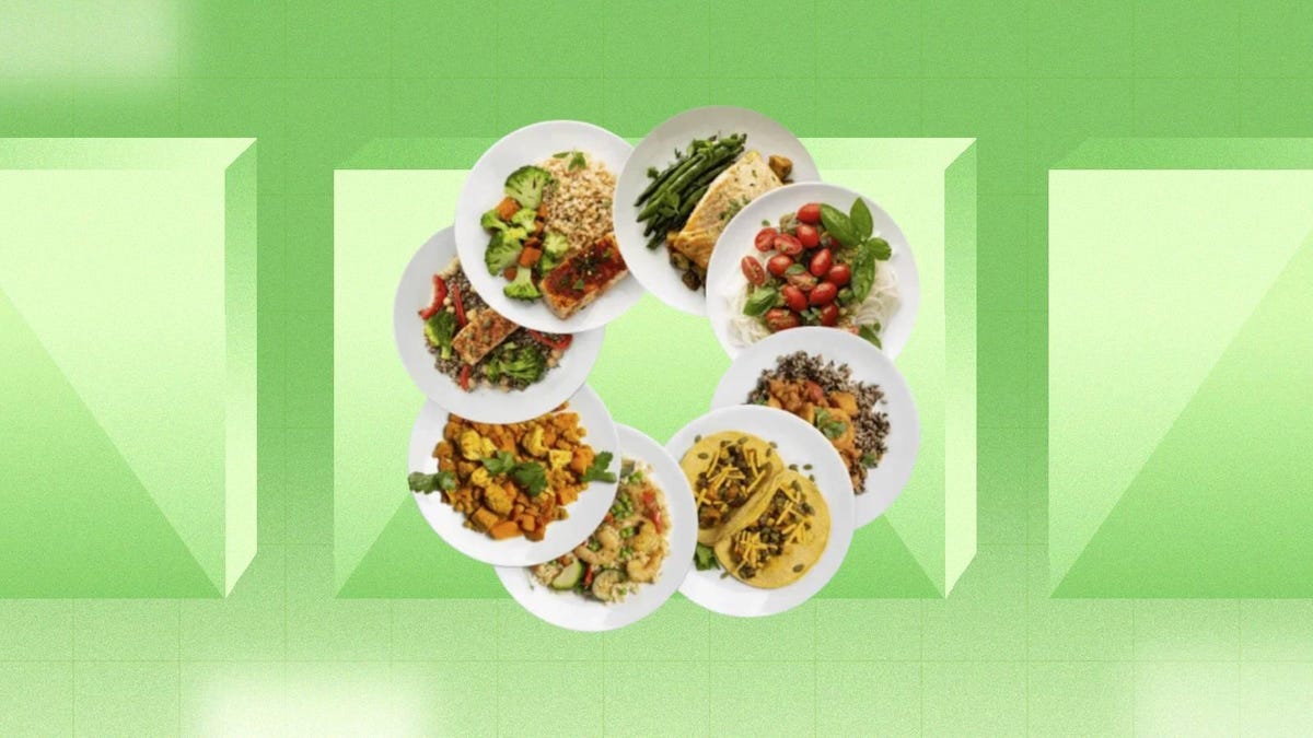 A circle of plates with various meals from ModifyHealth is displayed against a green background.