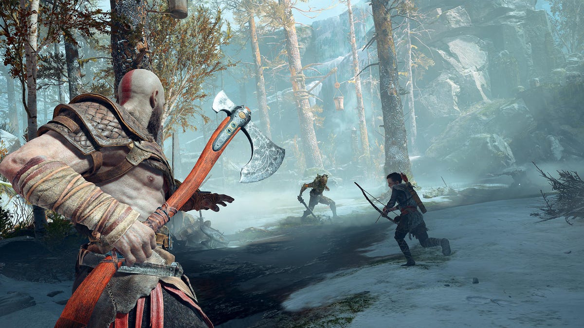 Kratos and Atreus battle a foe in a forest