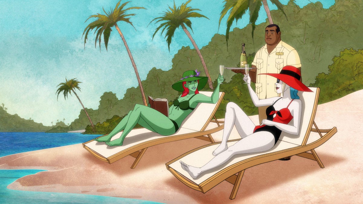 Harley Quinn and Poison Ivy lie on beach chairs while dressed in swimsuits