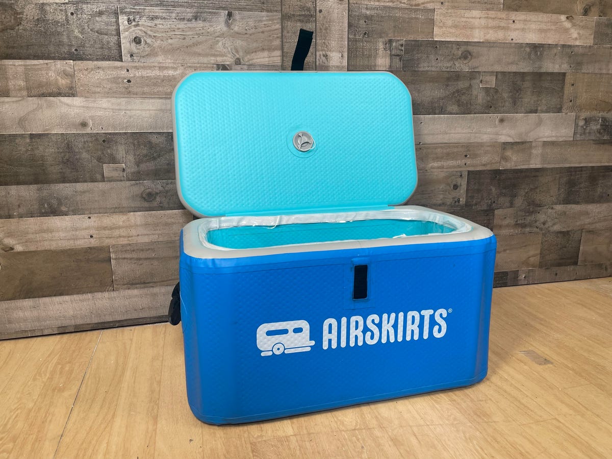 The AirSkirts inflatable cooler sits inflated and open against a wooden wall.