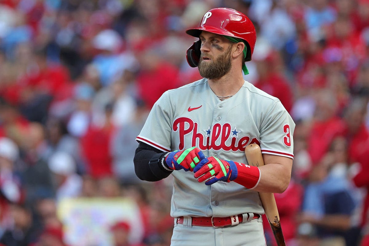 Philadelphia Phillies designated hitter Bryce Harper adjusts his gloves