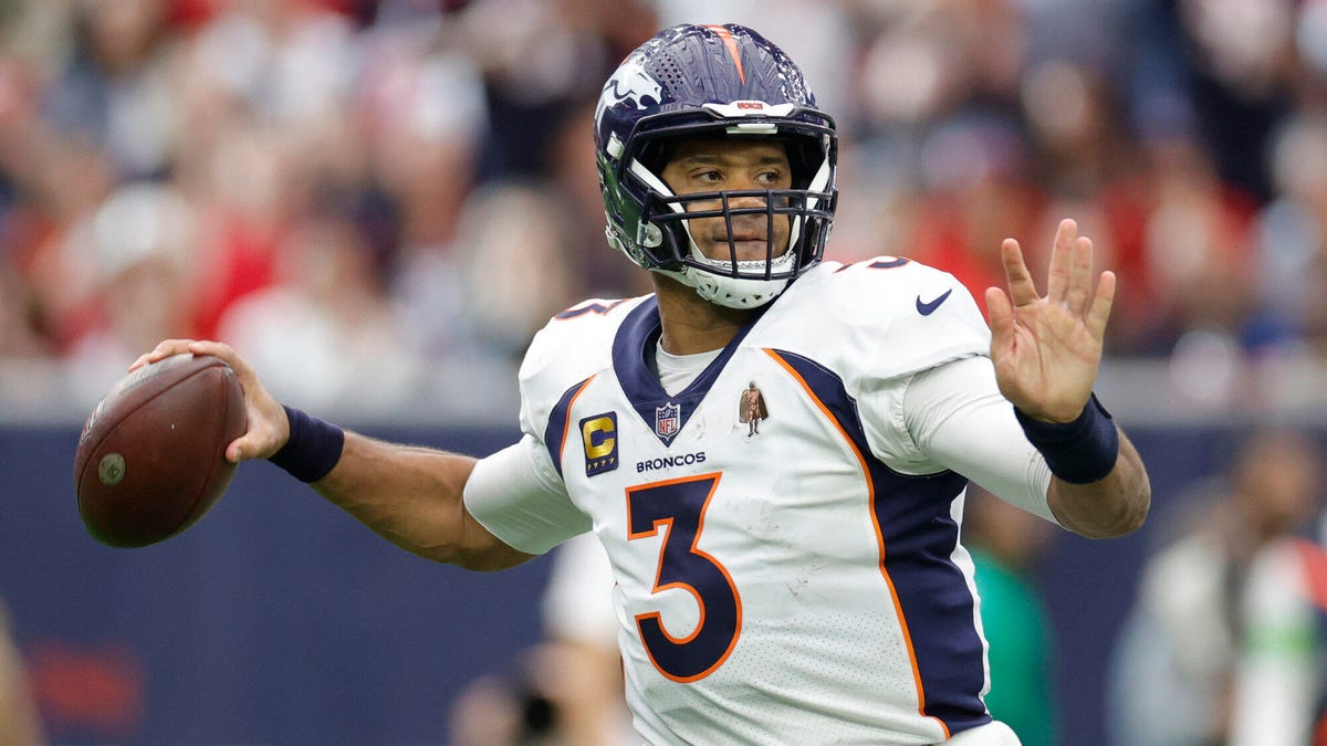 Russell Wilson of the Denver Broncos preparing to throw a ball with his right hand.
