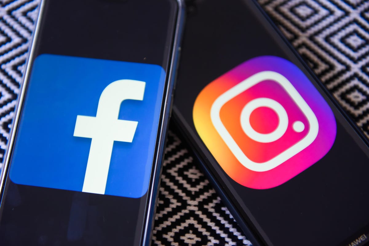Facebook and Instagram logos are seen on a mobile phones
