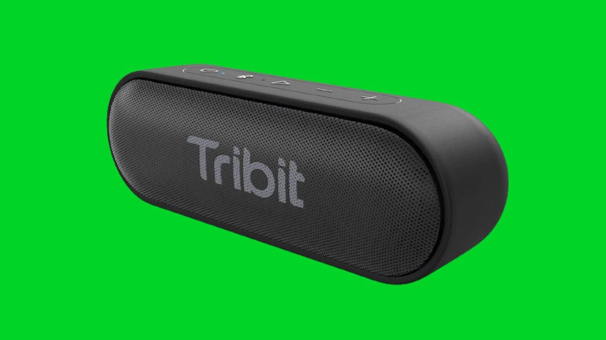 A black Tribit speaker against a green background.