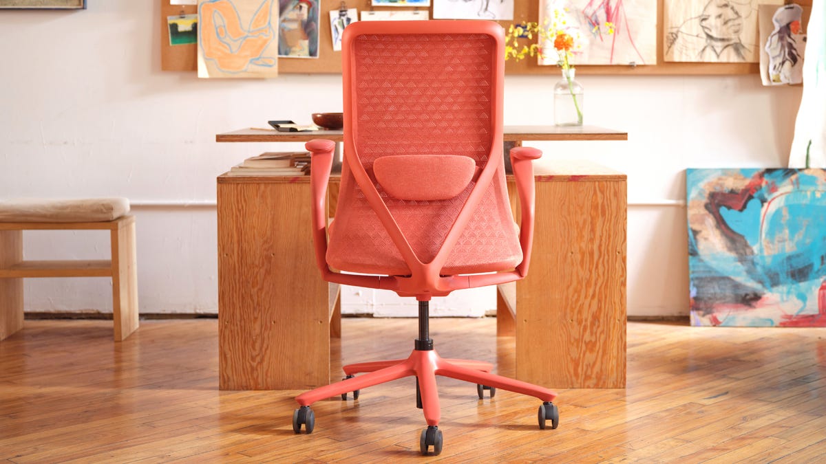 A coral office chair in front of a desk