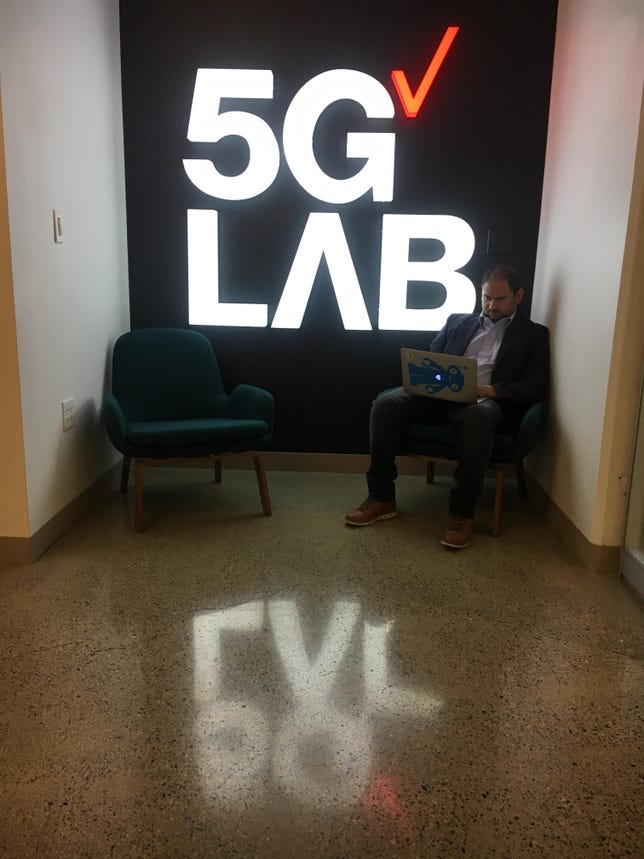 Southie Autonomy CEO Rahul Chipalkatty takes advantage of the wireless at Verizon's 5G lab.