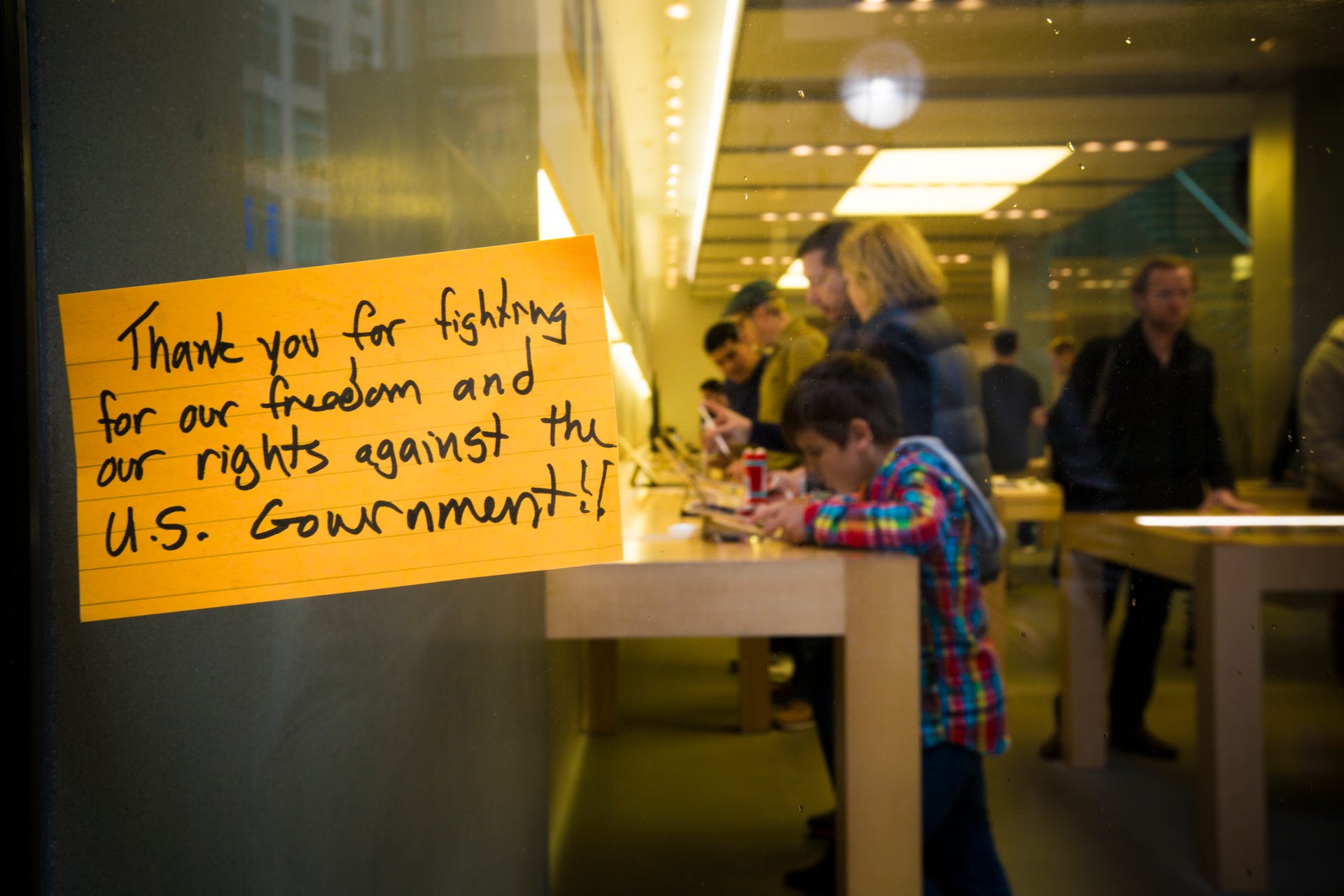 A note supporting Apple hangs on the window of one of the company's San Francisco retail stores.