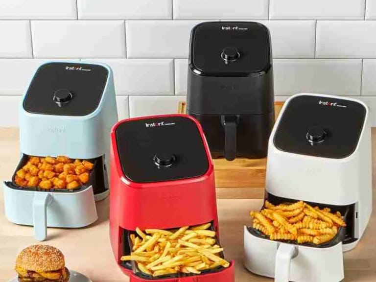 four air fryers in various colors
