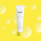 Supergoop sunscreen against a yellow background
