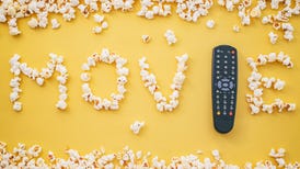 popcorn spelling the word movie and remote control