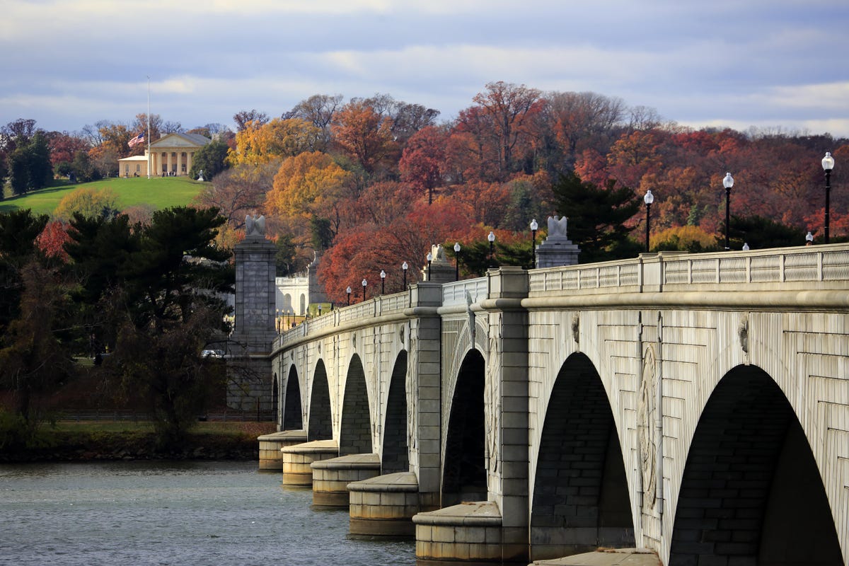 bridge over the Potomac leading to Arlington Cemetary, a hill covered in late fall foliage