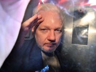 <p>WikiLeaks founder Julian Assange gestures from the window of a prison van as he's driven out of a London court on May 1, 2019, after being sentenced to 50 weeks in prison for breaching his bail conditions in 2012.</p>