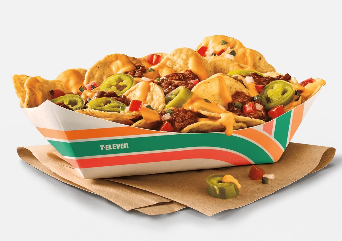 A serving of 7-Eleven nachos in a cardboard bowl