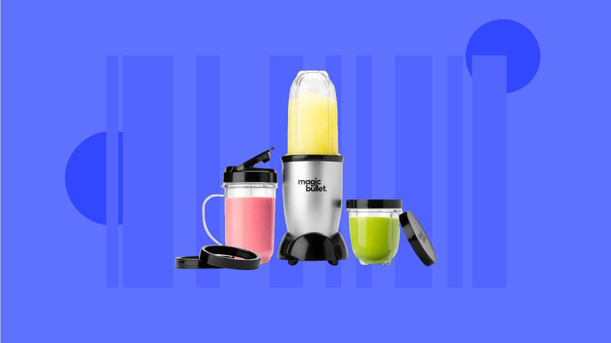 a Magic Bullet blender holding a bright yellow drink, with two full drink containers with lids next to it