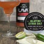 tin of margarita salt next to cocktail and pepper