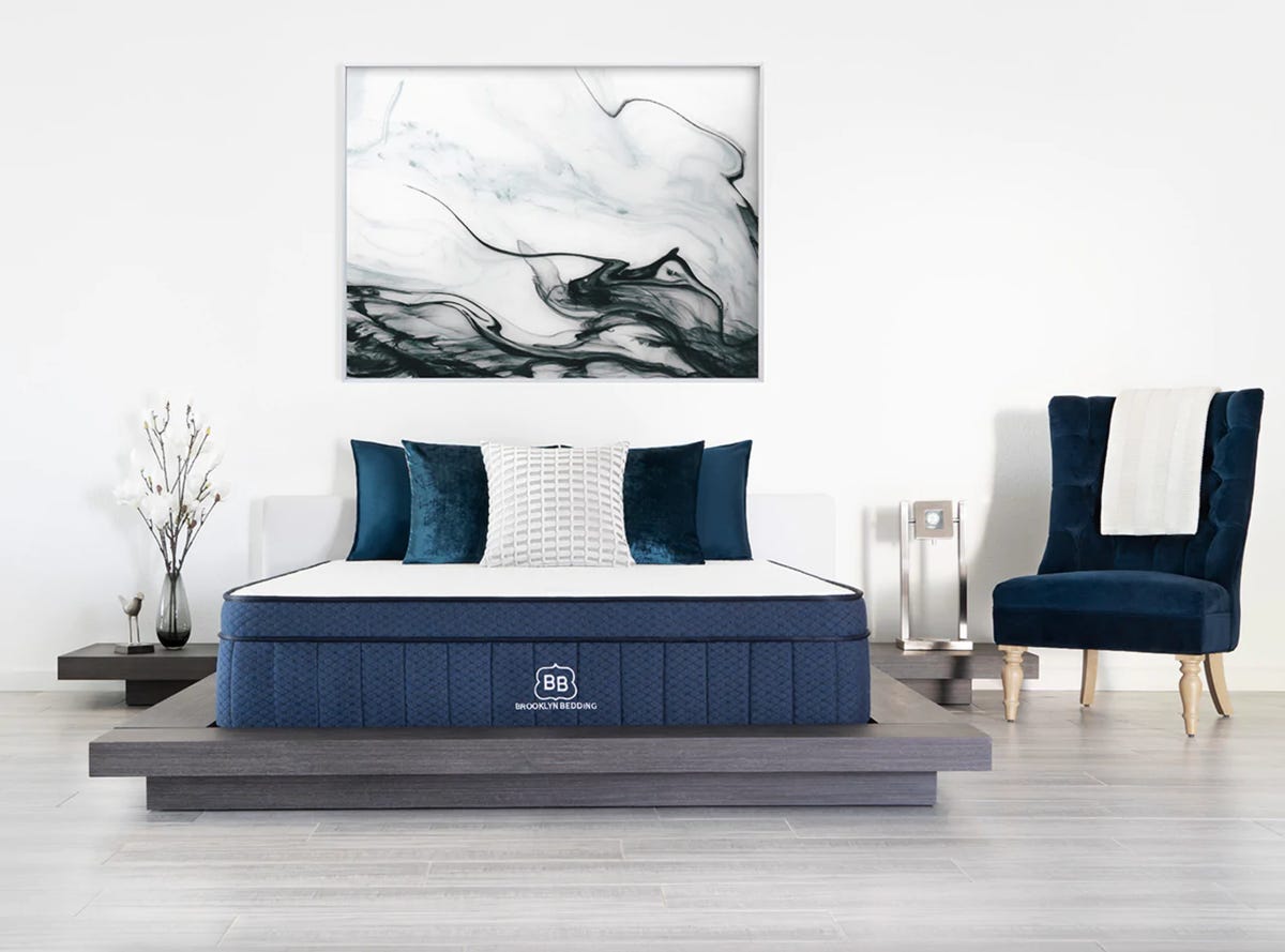 The Brooklyn Bedding Aurora mattress in a staged, decorated bedroom.