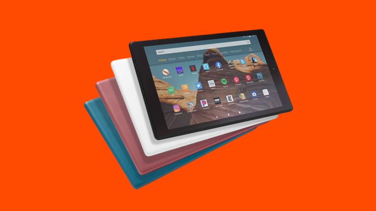 A stack of different color Fire 10 tablets against an orange background.