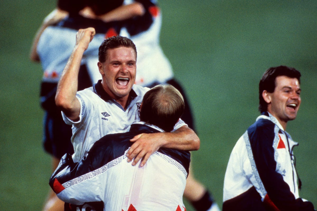 England footballer Paul Gascoigne celebrates a win by hugging a teammate.