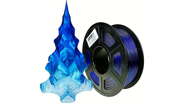 Roll of blue filament with an ice tree model next to it