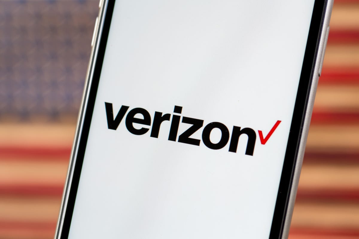 Verizon on a phone with a very blurry American flag in the background