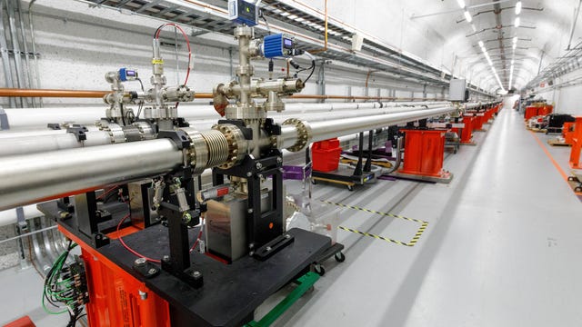 SLAC's newer LCLS facility for studying matter with intense X-ray laser pulses is divided into two sections. This tunnel links the two, with X-rays coasting along through the pipes after being generated upstream at a structure called the undulator.
