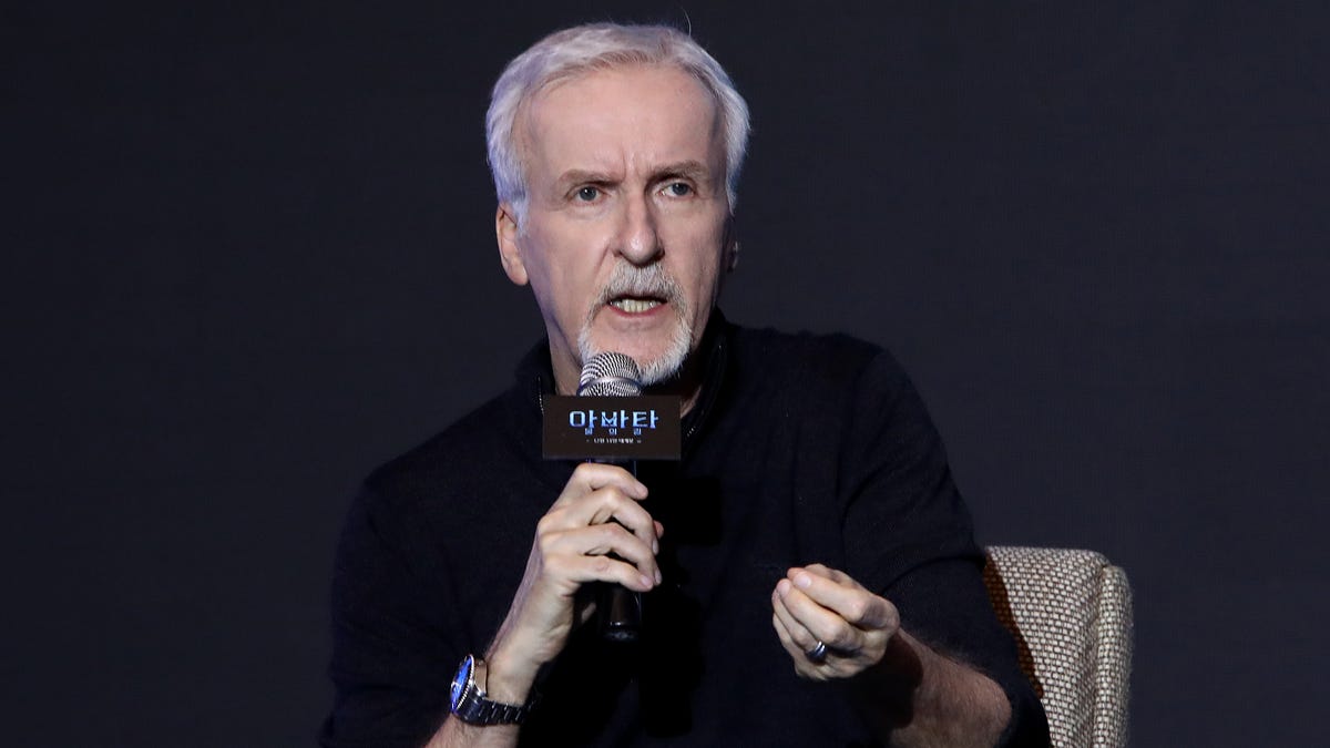 James Cameron talking into a microphone.