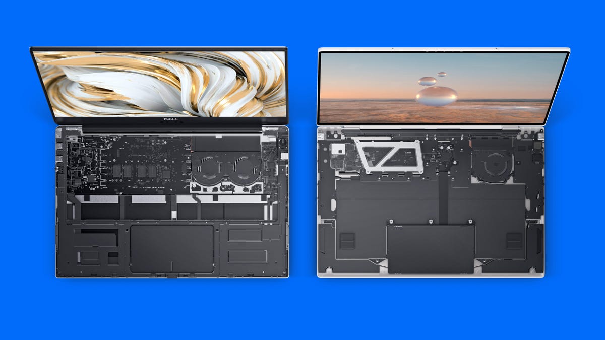 The Dell XPS 13 9305 on the left and new XPS 13 9315 on the right with the keyboards removed to show the internal components including the new model's smaller motherboard sitting on a blue background.