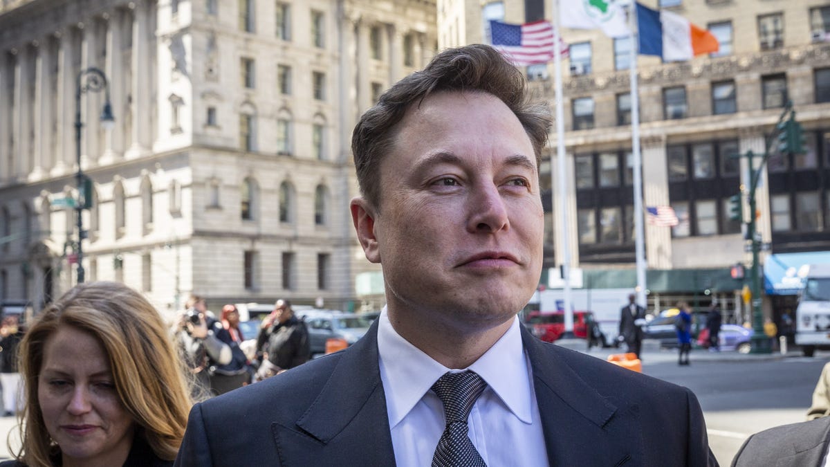 Elon Musk, wearing a suit, arrives at federal court in New York