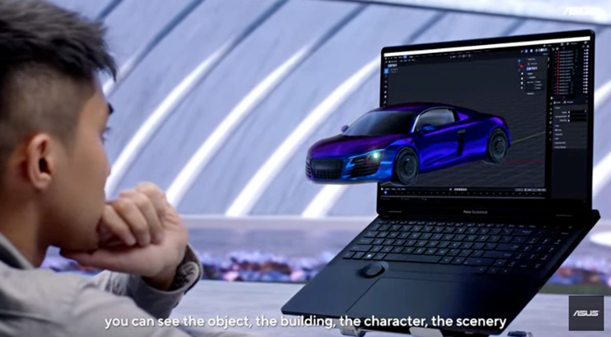 A man watches a 3D blue car emerge from his laptop screen