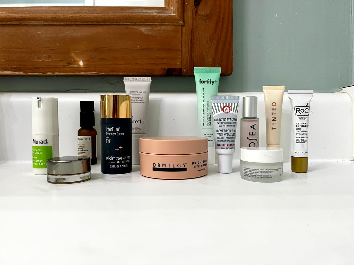 12 of the best eye creams on a bathroom counter.