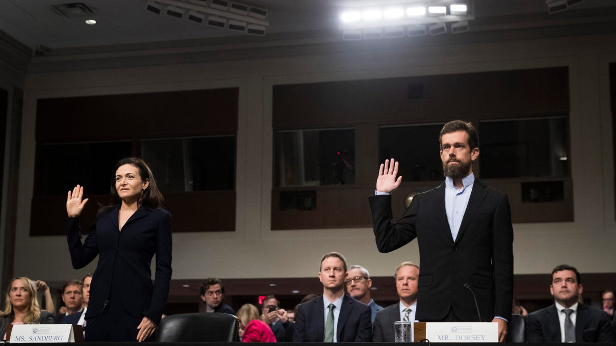 Facebook COO Sheryl Sandberg and Twitter CEO Jack Dorsey are sworn in at the start of the Senate intelligence committee hearing Wednesday. 