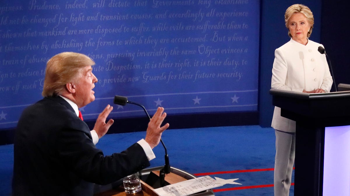 Republican nominee Donald Trump gestures as Democratic nominee Hillary Clinton looks on during the final presidential debate in Las Vegas in October 2016.