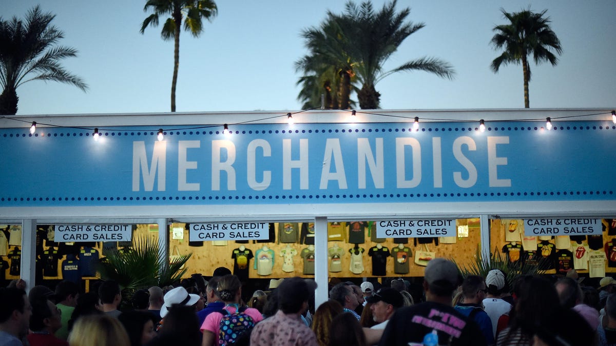 A merchandise stand in front of palm trees