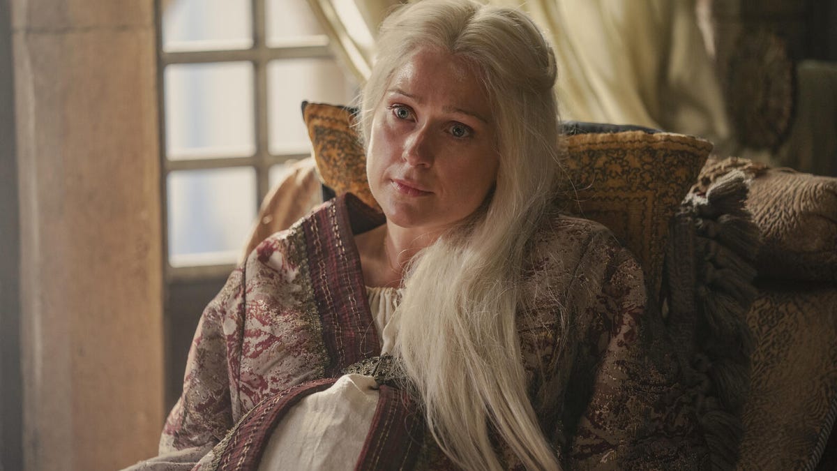 Aemma Targaryen, seated in a chair with pillows, looking weary