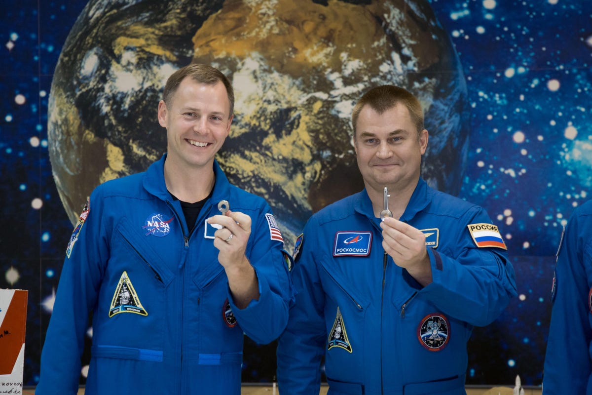 At the Baikonur Cosmodrome Museum in Kazakhstan, Expedition 57 Nick Hague of NASA (left) and Alexey Ovchinin of Roscosmos (right) display “launch keys” they were presented Oct. 6 during a traditional pre-launch tour of the facility. Hague and Ovchinin wil