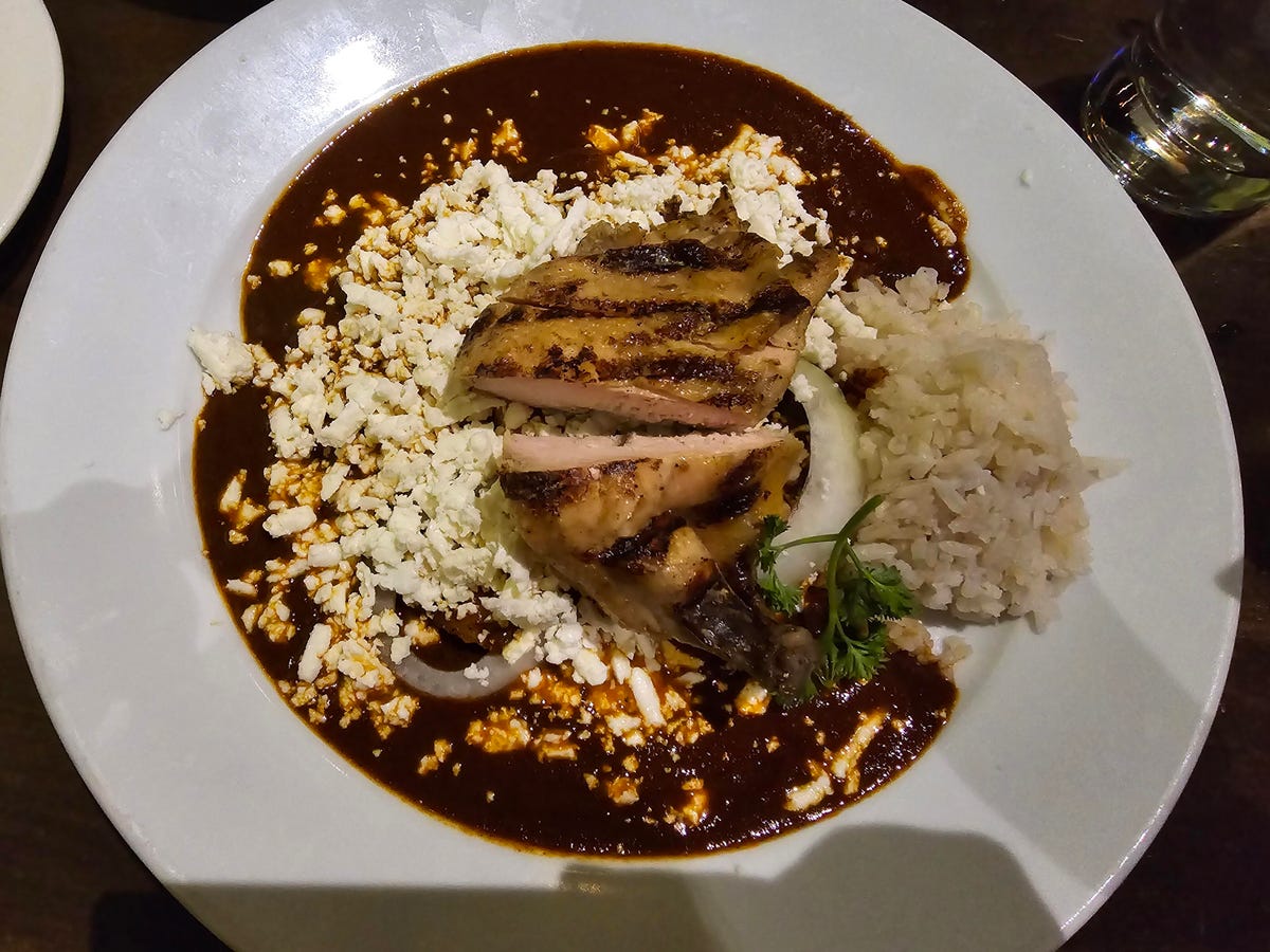 A photos of a plate of mole chicken and rice taken on the Galaxy S24 Ultra