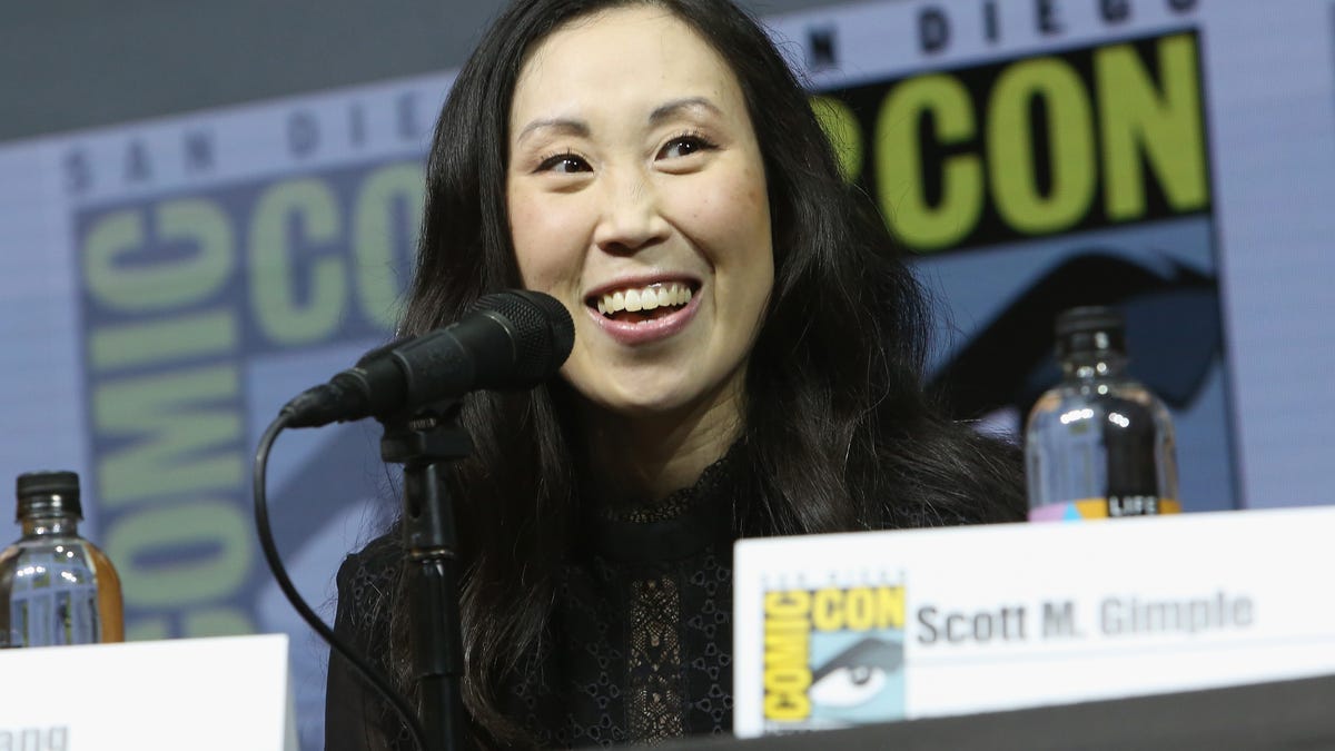 Angela Kang sits at a table at San Diego Comic-Con in 2018