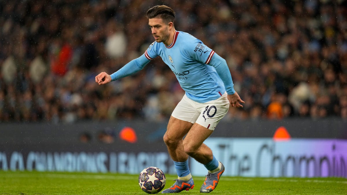 Manchester City forward Jack Grealish running with the ball.
