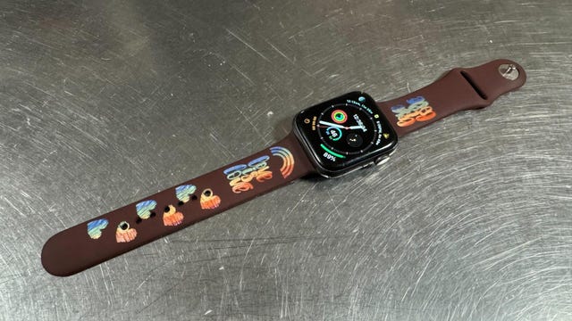 Red watch strap with rainbows and hearts on it