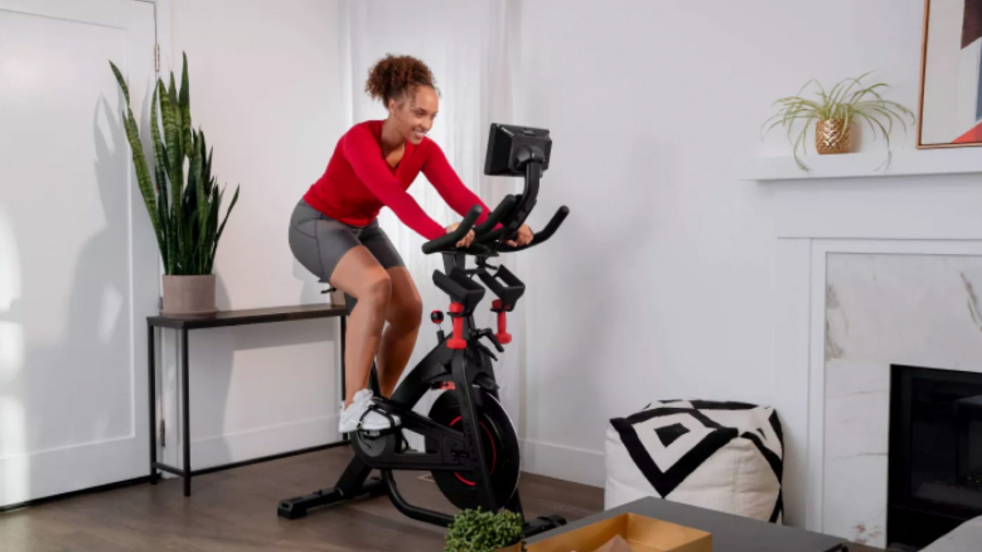 A woman riding the Bowflex C7 exercise bike in her living room.
