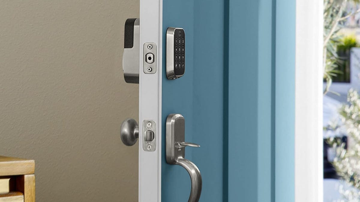 The Yale Assure Lock 2 shown on a blue door that&apos;s open to show both inside and outside components.