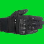 Alpinestars Corozal Drystar motorcycle gloves on a green background