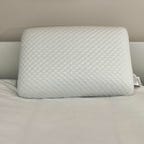 GhostPillow on top of a white bed