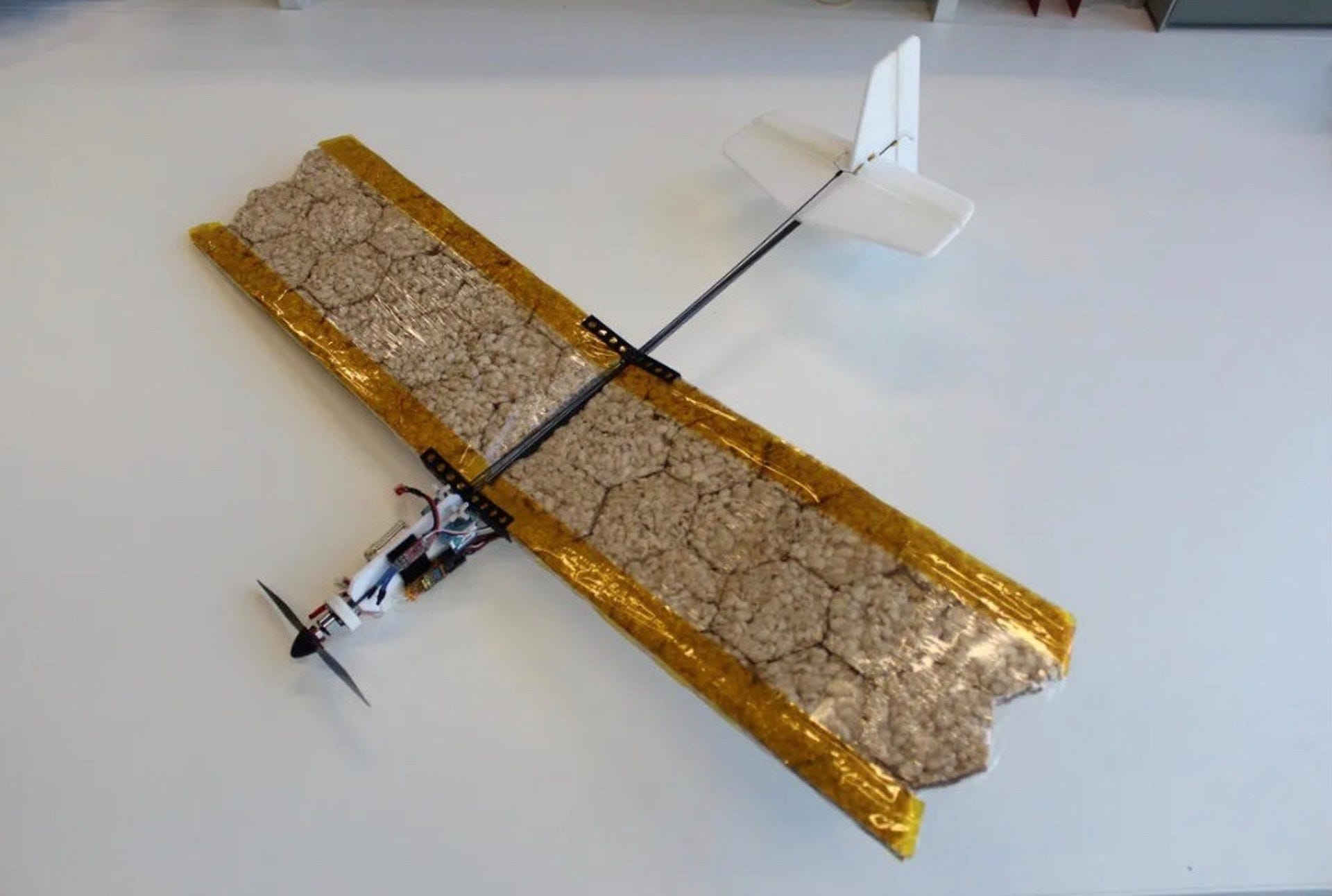 A propeller drone with wings made of rice cakes like a tiny edible airplane.