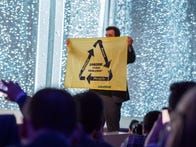 <p>A Greenpeace protestor got on stage during the Samsung event on Sunday. </p>