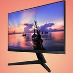 Samsung monitor displaying colorful pastel sunset and boat on water