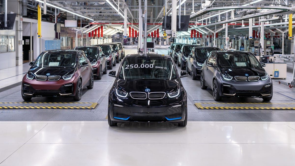 A group of BMW i3 EVs lined up at the factory